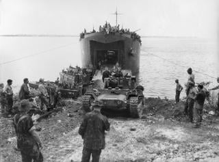 Squarepeg�s D-Day landings on Nissan Island were virtually flawless, with Kiwis and their equipment disembarking and being unloaded from sequentially arriving waves of landing craft and ships. Above: U.S. sailors and New Zealand soldiers watch as a Mk IIICS Valentine tank rumbles ashore from LST-446. 